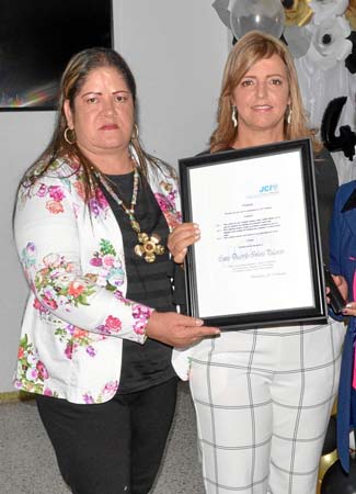 Esperanza Valencia Rendón le entregó un reconocimiento a Luz Elena Mejía González, en nombre de la Cámara Junior Internacional.