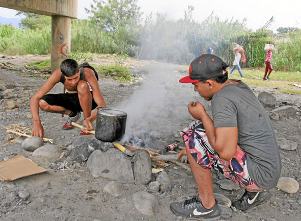 Elías Méndez cocina bajo la estructura que comunica a Cúcuta con el estado venezolano del Táchira.