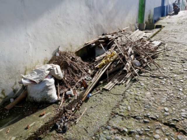 Escombros que se apilan en los andenes contribuyen a la humedad que deteriora la calzada.