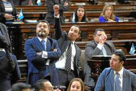 El diputado Cristian Gabriel del partido oficialista hace gestos de burla contra opositores al gobierno de Jimmy Morales. 