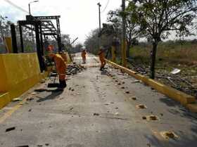 Personal de la Agencia Nacional de Infraestructura recoge los escombros de los peajes detonados por el Eln.