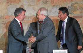 El presidente de Colombia, Juan Manuel Santos, estrecha la mano del Comisionado de la CIDH, Francisco José Eguiguren, durante la