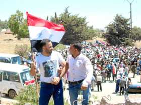 Foto | Efe | LA PATRIA Dos hombres ondean una bandera siria en la plaza de al-Tahrir, en la ciudad liberada de Quneitra, al sur 