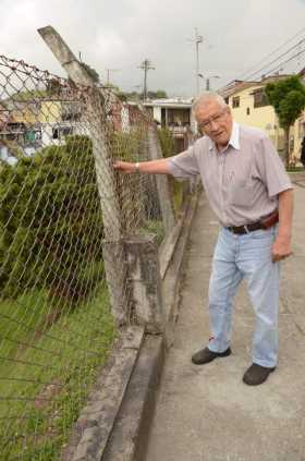 Silvio Colorado, habitante del barrio, muestra el muro en mal estado. La base está floja y se mueve.