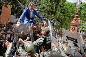 Foto | EFE | LA PATRIA  El líder opositor venezolano Juan Guaidó trepa una reja en un intento por ingresar a la Asamblea Naciona