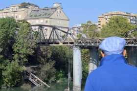 Un hombre mira el histórico puente Ponte dell'Industria, o Ponte di Ferro, después de que un incendio lo dañara, en Roma (Italia