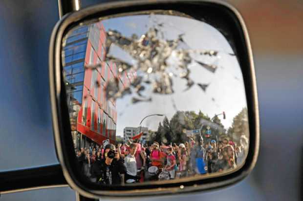 Reflejo de los manifestantes en un retrovisor roto durante la marcha Bienvenidos al infierno. Reflejo de los manifestantes en un retrovisor roto durante la marcha Bienvenidos al infierno.