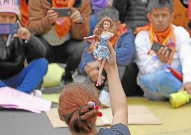 Foto | EFE | LA PATRIA Una activista demuestra con una muñeca los diferentes tipos de abuso durante una marcha de padres de fami