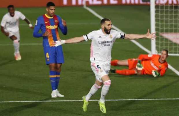 El delantero del Real Madrid Karim Benzema celebra su gol, primero del equipo ante el FC Barcelona, durante el partido de la jor