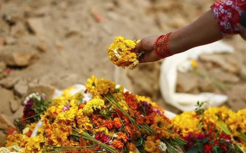  Una mujer deposita flores en la plaza de Durbar en memoria de las víctimas mortales del terremoto del pasado 25 de abril en Katmandú (Nepal).