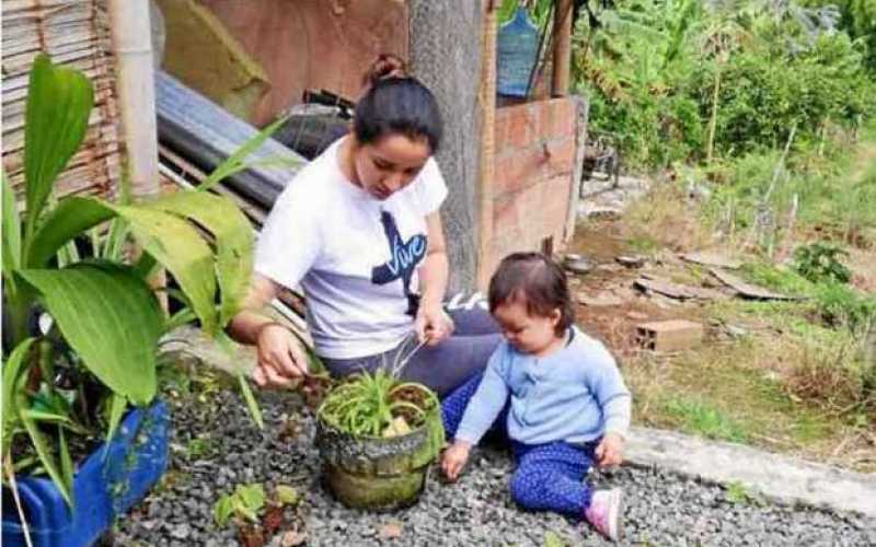Maria Camila Tangarife Chávez comparte junto a su hija Isabella Gallego Tangarife en la finca enseñándole a plantar.